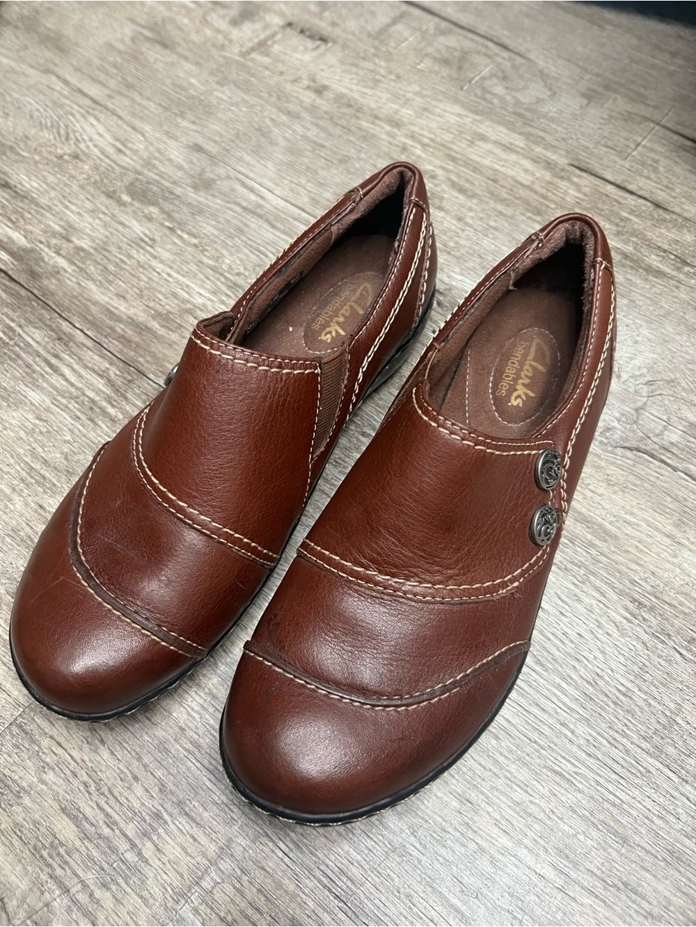 Clarks bendable size 7.5 Brown Leather Slip-On Loafers with Button Accents